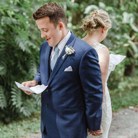 Couple reading notes to each other during their first touch on their wedding day.