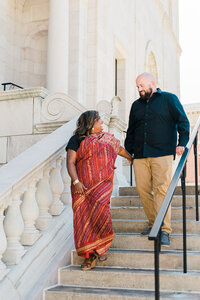 engaged-couple-walks-down-the-steps-of-a-minnesota-library