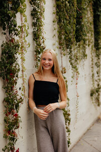 senior teenager wearing pink dress, smiling at camera