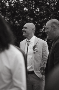 A groom mingling and smiling with his wedding guests during his cocktail hour in Buena Vista, Colorado.