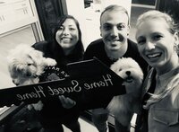 Happy homebuyers smiling and holding a ‘Home Sweet Home’ sign, featured as a client testimonial for San Diego realtor Mary Pernicano — Mary Pernicano Real Estate.