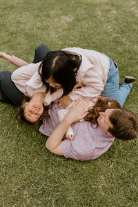 Photo of a family playing on the ground
