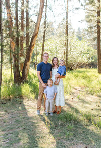 mom holding infant close and giving kiss on the cheek for by st george photographer sadie peterson photography