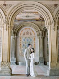 bride and groom pose together in central park in fine art portrait
