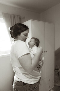 a mother holding her child documented by a Sudbury Documentary Photographer