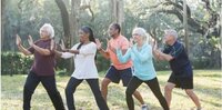 People doing tai chi together in a park