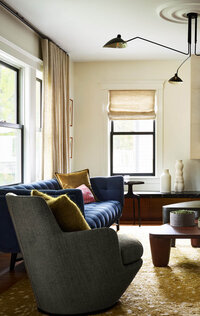 Interior designers in Boston designed a modern mix of furniture for a historic home renovation project in Brookline, MA, blending old and new seamlessly.
