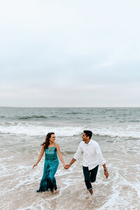 couple holding hands on beach