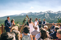 Wedding ceremony with guests and couple with amazing Breckenridge mountain backdrop
