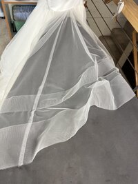 a wrinkled bridal gown layer before steam and press services