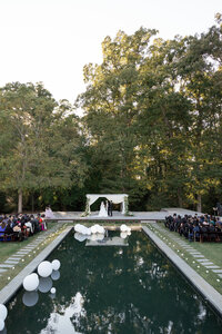 groom kissing bride next to creek virginia wedding