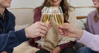 Content Club students clinking champagne glasses in celebration of a successful year in business.