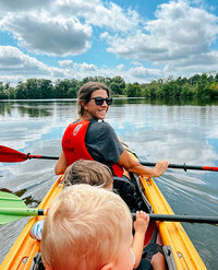 A woman and two children enjoying a kayak on a river in Delaware County, Ohio.