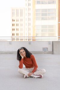 girl sitting at a parking garage during a senior session in Reston, Virginia by a Northern VA senior photographer