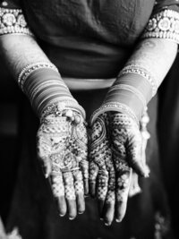 indian bride showing henna on hands