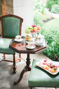Tea Cups and Teapot on Table with a Fruit Bowl