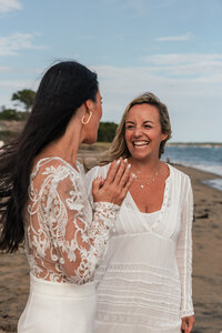 kat smiling with black jacket on shoulders