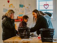 Grocery store owner helping customers