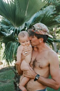 father holding his  baby kissing them