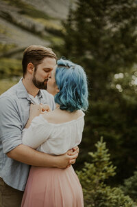 Couple kissing in the mountains of Breckenridge during their engagement session.
