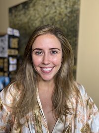 Woman with blue eyes before makeup in a floral silk robe