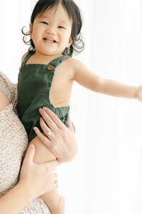 One year old smiles in olive green overalls, central indiana Photography