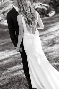 Photo of groom hugging bride taken by Portland Maine wedding photographer