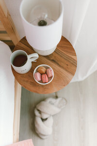 Coffee macroons and lamp on bedside table real estate open house