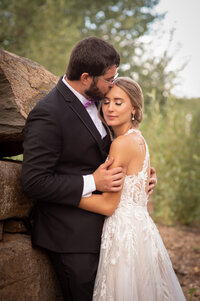 Bride and groom embrace on a winding staircase