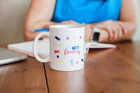 A mug with the two lauras logo