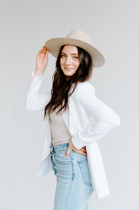 Woman smiling and posing with hat