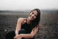 Woman smiling at camera in black top