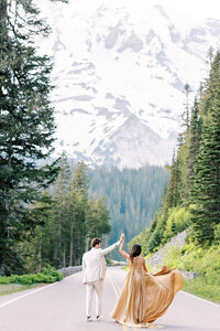 couple dancing in the street with a mountain backdrop