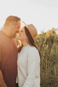 husband and wife snuggle together during portraits with Allyson Blankenburg in Houston Texas.