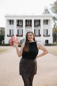 Cheerful headshot with pom-pom at University of Alabama