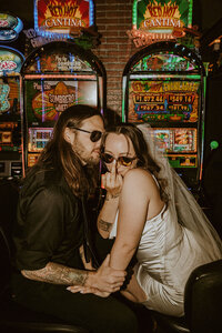 bride flips off camera in front of slot machines in las vegas
