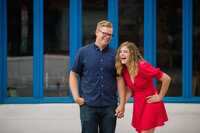 engaged couple laughs together