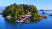 Private Island with large green trees surrounded by bright blue water