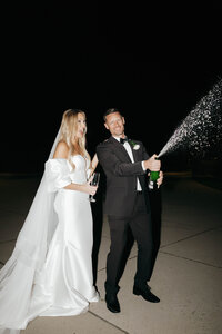 Bride and groom share a bottle of champagne after saying I do, flash film photography in CDA, ID