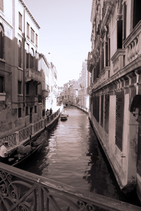 Gondola on a canale in Venice at sunset in sepia tones