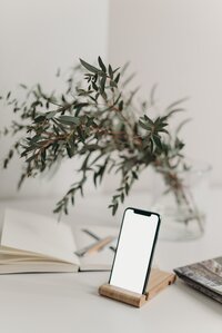 flowers and cell phone on top of desk