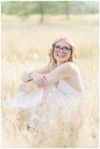Senior guy smiles with arms crossed for Hamilton Montana senior pictures