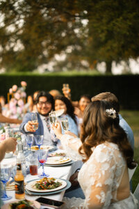 Bride and groom popping champagne at their wedding