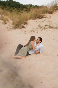 Couple lays together in the sand among the Indiana Dunes