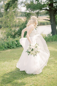 bride dancing with bouquet