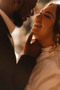 Birmingham AL engagement photographer captures timeless bar photos of couple, smiling closely and romantically