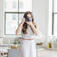 woman holding a camera, best milwaukee wisconsin brand photography services for women brands and entrepreneurs