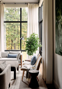 Boston interior design for a Vermont new construction mountain house living room with linen drapes, modern furniture, and warm, inviting details. 