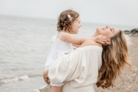 dad smiling with his daughter at his connecticut family session