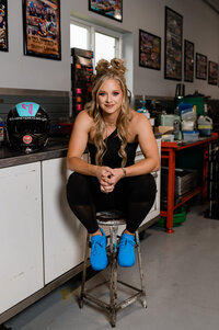 megan meyer sitting on a stool while smiling